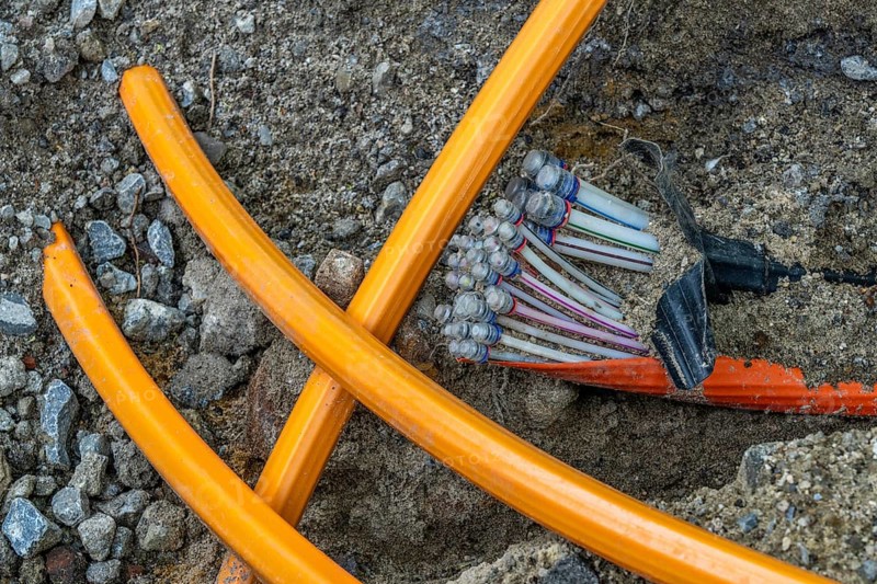 Laying of fibre optic cables, empty conduits are laid under a pavement, in which the actual fibre optic cable is later blown in and connected to the respective house connection or distributor. Essen, North Rhine-Westphalia, Germany, Europe