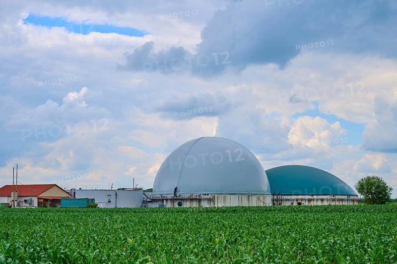 Modern biogas plant in the middle of green fields under a cloudy blue sky, summer, Middle Franconia, Bavaria, Germany, Europe