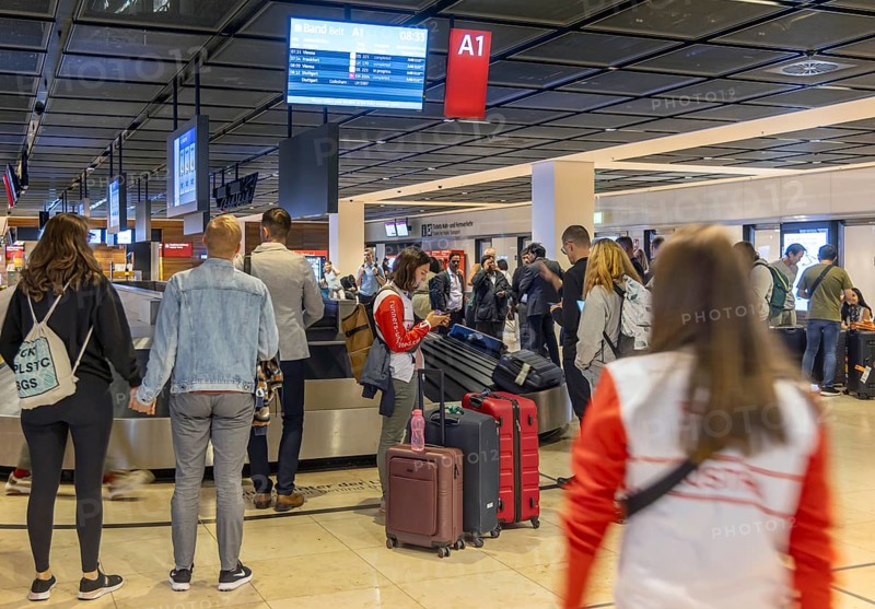 Berlin-Brandenburg BER Airport. Passengers waiting for their suitcases at baggage reclaim. Berlin, Germany, Europe