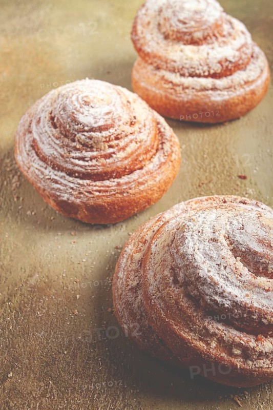 Bakery product, lemon twist, with white glaze, sweet bun, muffin, pastries, top view, no people