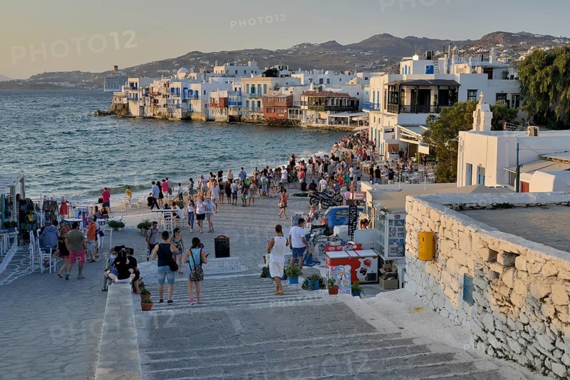 Tourists watching the sunset in Little Venice, Chora or Mykonos Town, Mykonos, Cyclades, Greece, Europe