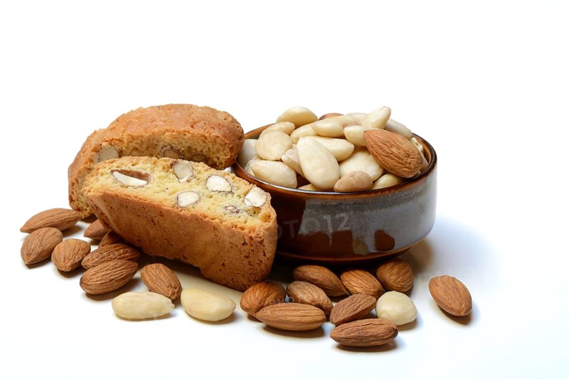 Cantucci and almonds in small bowls (Prunus dulcis)