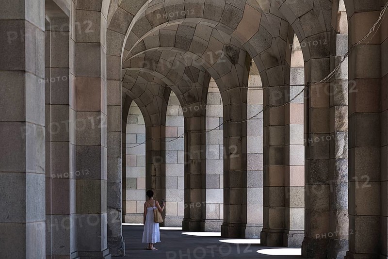 Lady in a white dress in the arcade of the Congress Hall, unfinished National Socialist monumental building on the Nazi Party Rally Grounds, Nuremberg, Middle Franconia, Bavaria, Germany, Europe