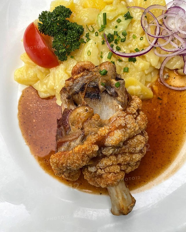 Half pork knuckle, crispy fried, potato salad, tomato, chives, parsley, onion rings, plate, food, Stuttgart, Baden-Württemberg, Germany, Europe