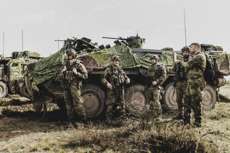 Soldiers in front of a Pandur II 8x8 of the Czech army, taken during an exercise of the Bundeswehr with forces from Norway and the Czech Republic during the exercise 'Wettiner Schwert' as part of Quadriga 2024 in the training town of Schnöggersburg, 08.04.2024