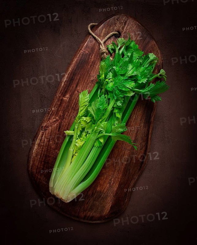 Fresh bunch of celery, top view, no people, on a dark background