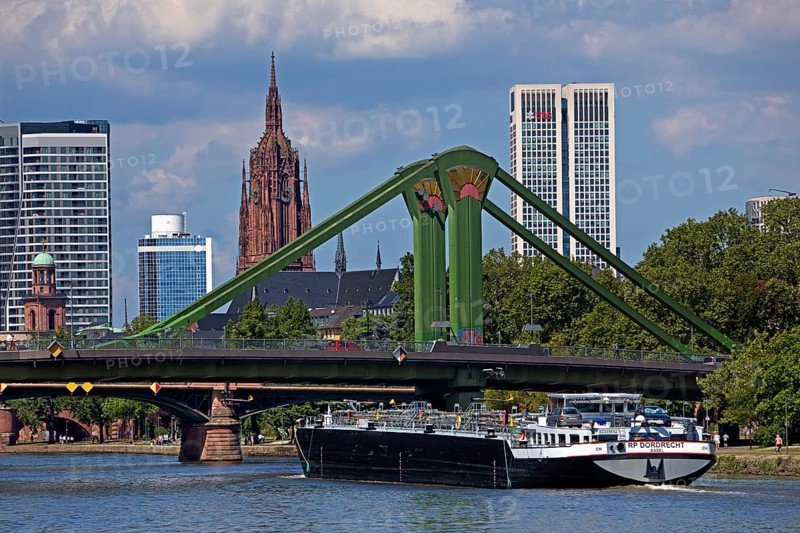 The river Main with a barge in front of the rafter bridge and the imperial cathedral of St Bartholomew, Frankfurt am Main, Hesse, Germany, Europe