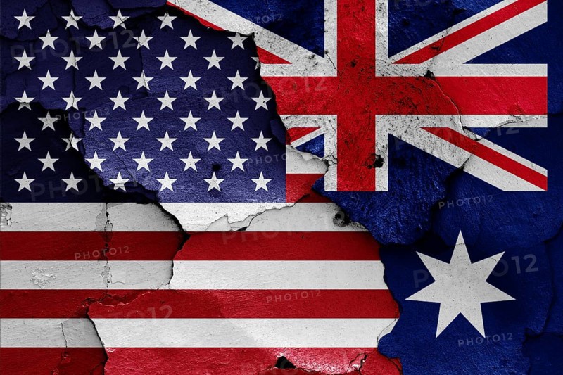 Flags of USA and Australia painted on cracked wall