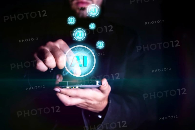 Close up of businessman hand holding mobile phone with creative AI hologram