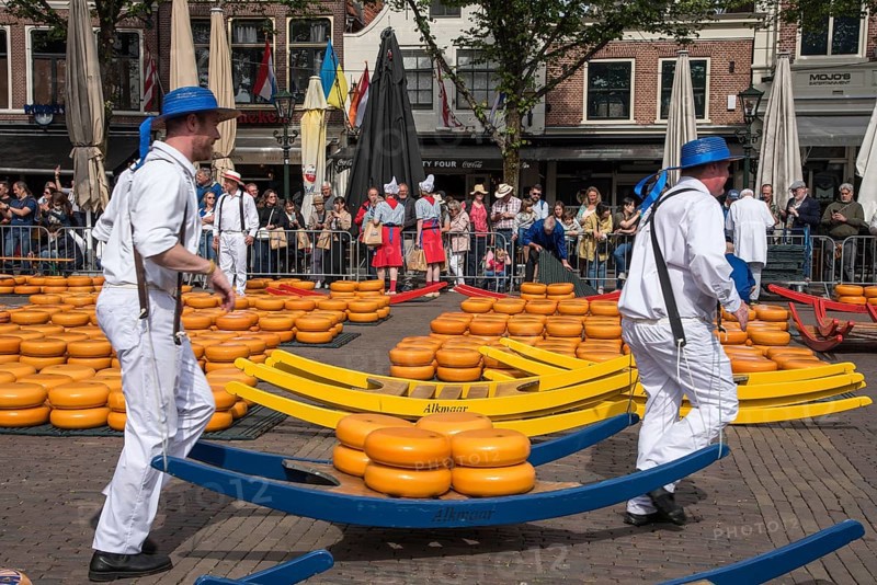 Alkmaar, Netherlands, May 2022. The cheese carriers, with their colored straw hats, at the Alkmaar cheese market