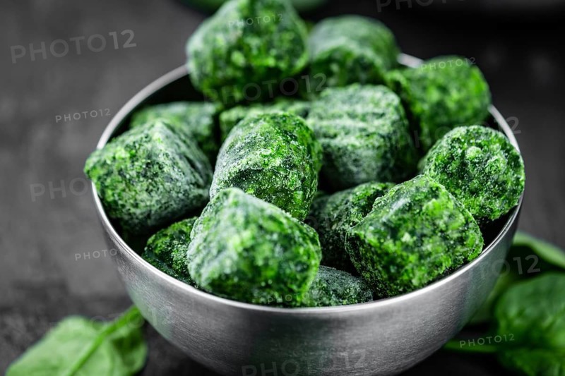Frozen spinach cubes as detailed close up shot (selective focus)