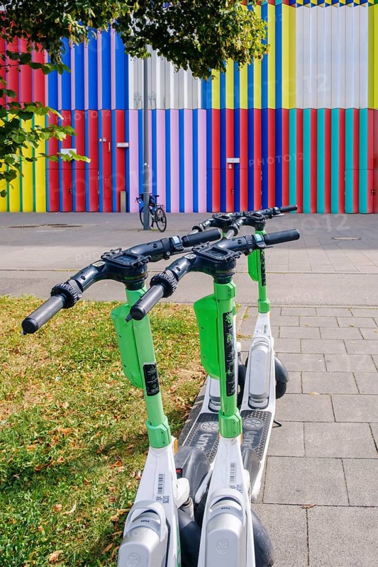 E-scooter in front of the colourful façade of the Mira shopping centre on the Nordhaide in Munich