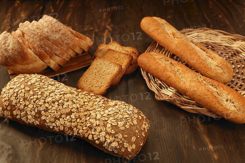 Varied bread still life over dark wood background