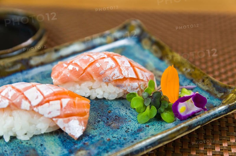 Plate with two elegant nigiri sushi (nigirizushi) with diamond-shaped knife cuts