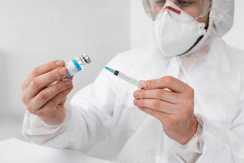 Close up doctor holding covid vaccine