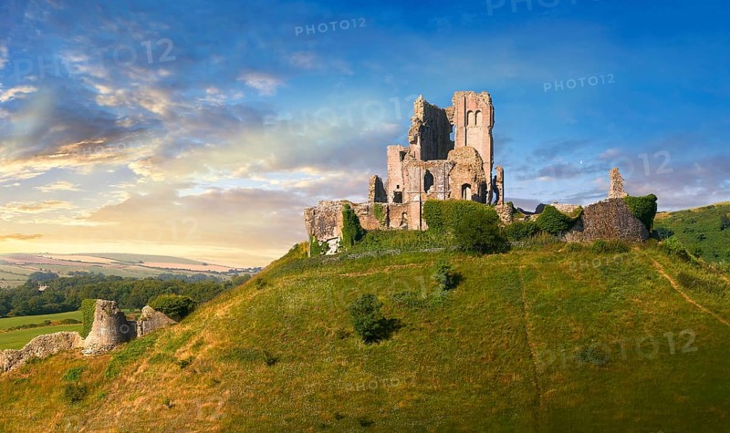 Medieval Corfe castle keep & battlements at sunrise, built in 1086 by William the Conqueror, Dorset England