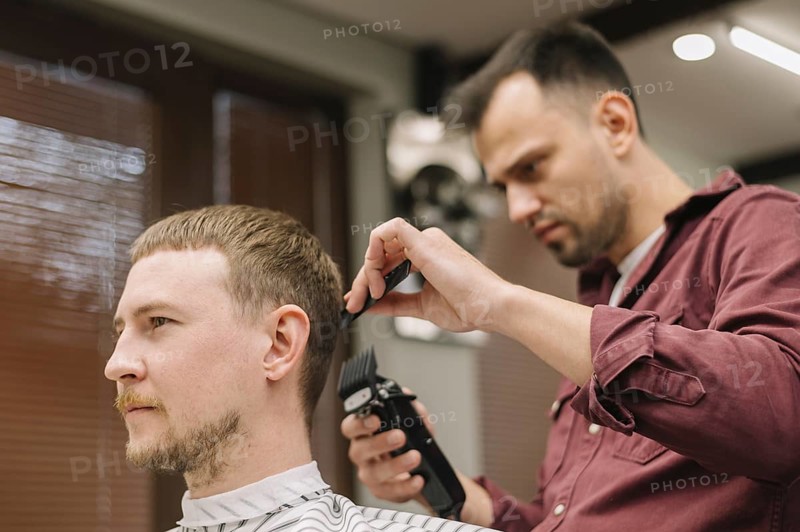 Low angle hairstylist giving haircut