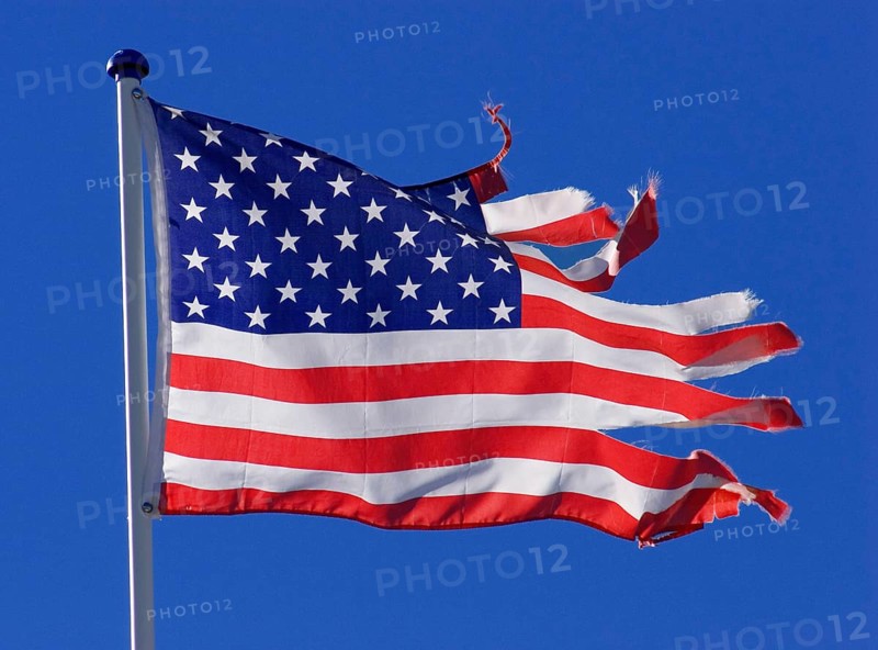 Stars and stripes, US national flag, torn, ripped, tattered, flutters flaps in the wind