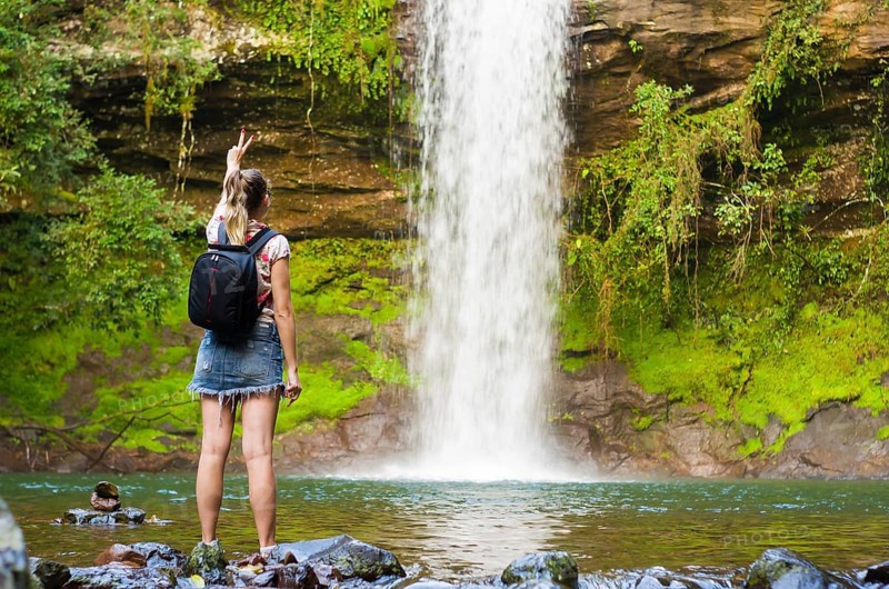 Jung woman in front of waterfall, Maquine, Rio grande do sul, Brazil, South America