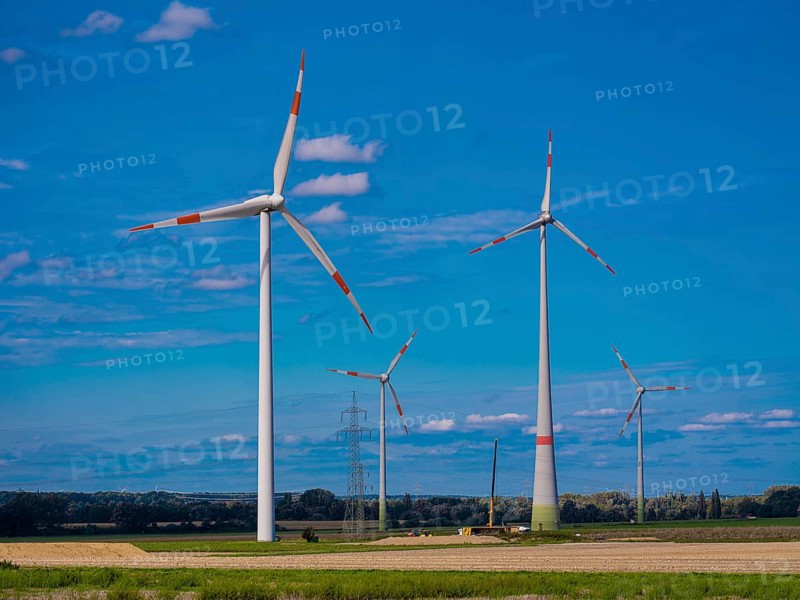 Wind turbines and high-voltage pylons with power lines at the Schacht Konrad wind farm, Salzgitter, Lower Saxony, Germany, Europe