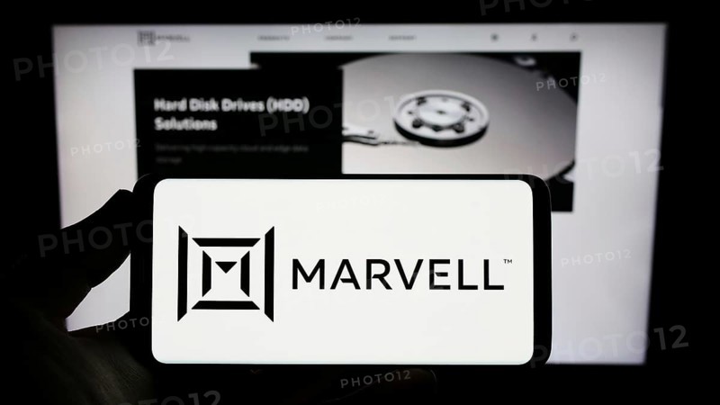Stuttgart, Germany, 12-30-2022: Person holding smartphone with logo of US semicondurctor company Marvell Technology Inc. on screen in front of website. Focus on phone display, Europe