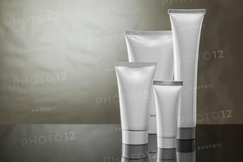 Higiene products four white plastic tubes on vintage background