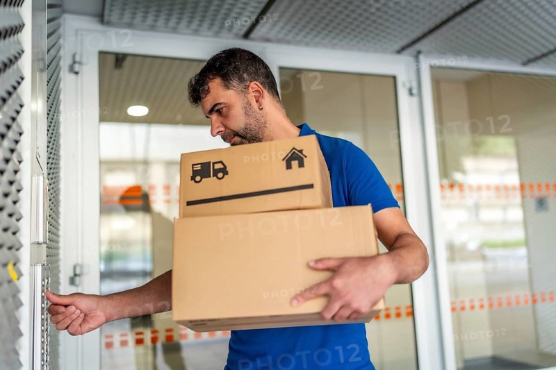 Delivery person uses the intercom of a house to deliver a package