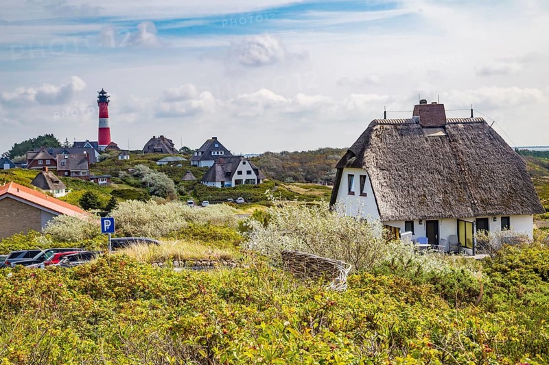 Lighthouse and thatched-roof villas of the Kersig estate in the dunes, Hörnum, Sylt