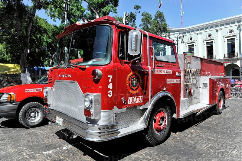 Merida, Yucatan, Mexico, Central America, Red fire engine on a city street, surrounded by historic buildings, Central America