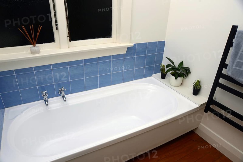 Interior of a retro bathroom with a bathtub and toilet