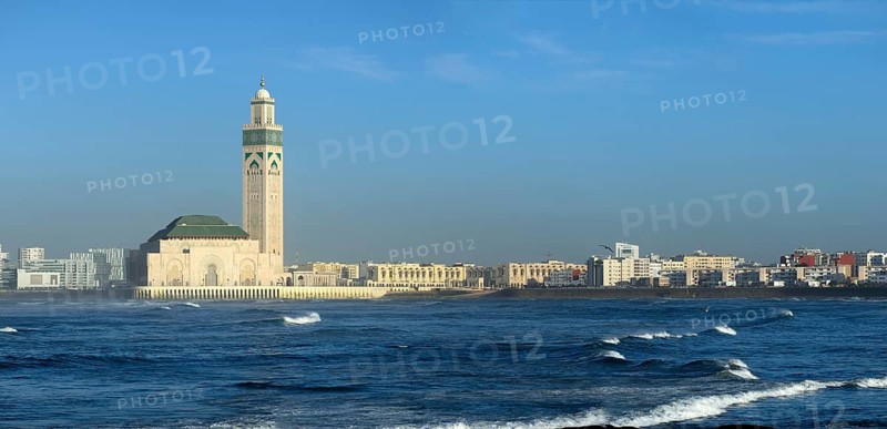 Hassan II mosque in Casablanca and Atlantic ocean waves at sunset, Morocco, panorama, Africa