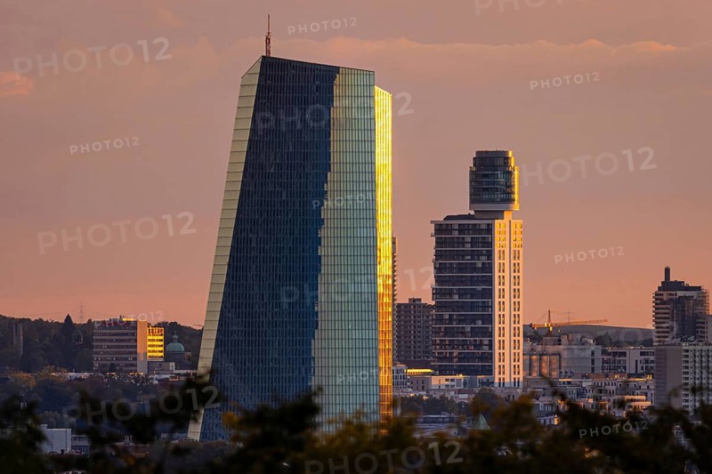 The light of the setting sun falls sideways onto the glass façade of the European Central Bank (ECB) and the Henninger Tower in Frankfurt am Main, Lohrberg, Frankfurt am Main, Hesse, Germany, Europe