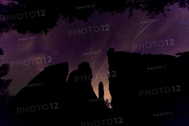 Pereids over Saxon Switzerland. Hercules Pillars in the Bielatal, the striking rock formations stand out impressively against the night sky. The shooting stars race across the night sky at 216, 000 km h and burn up