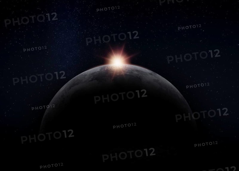 View of the dark hidden side of the Moon with the Sun behind it. Negative space for copy text. Elements of this image furnished by NASA