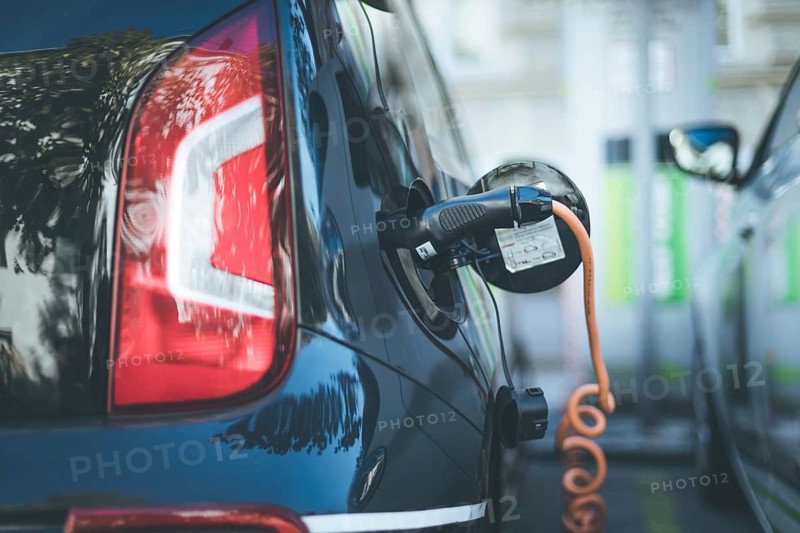 Electric car recharging with charge cable and plug leading to charge point