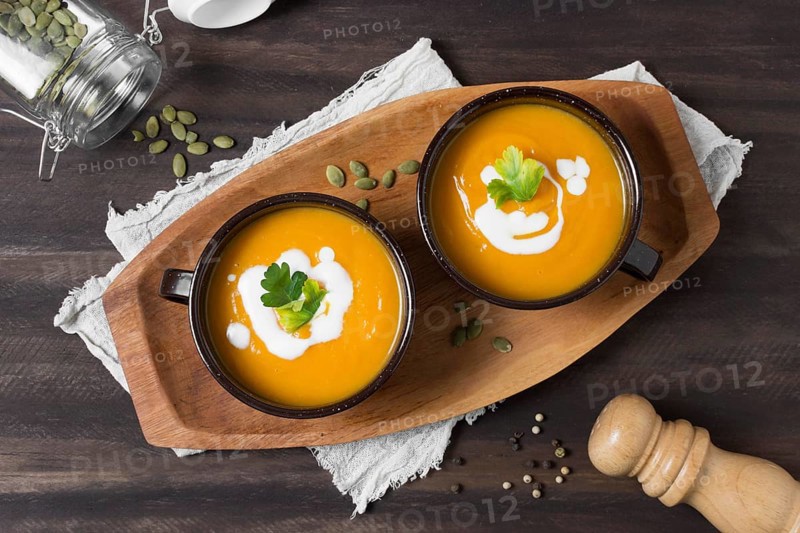 Flat lat bowls with pumpkin soup