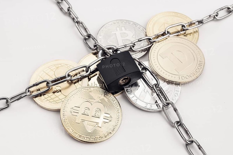 Cryptocurrency security concept. Group of crypto coin protected by chain and padlock