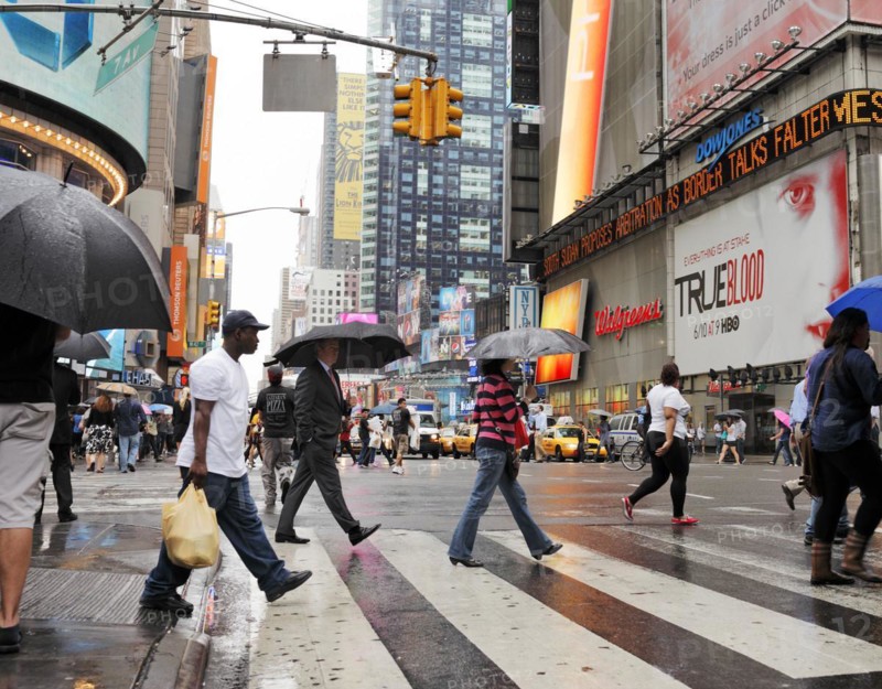 NEW YORK CITY, USA, JUNE 12: People crossing a street at rainy Times Square. June 12, 2012 in New York City, USA, North America