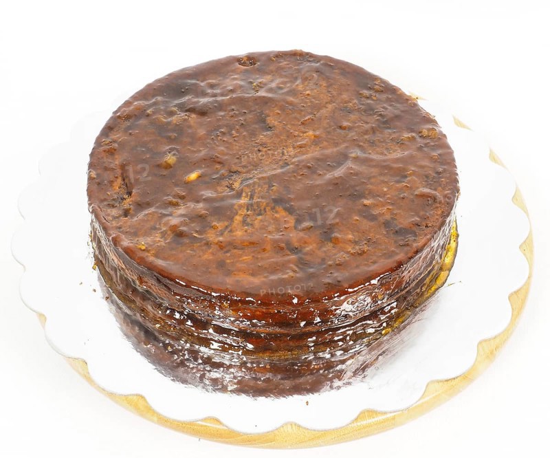 Half stage on sacher torte chocolate cake on silver mirror plate towards white