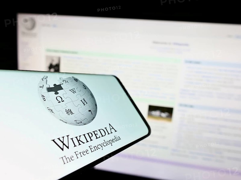 Stuttgart, Germany, 01-08-2023: Smartphone with logo of online encyclopedia Wikipedia on screen in front of website. Focus on center-right of phone display, Europe