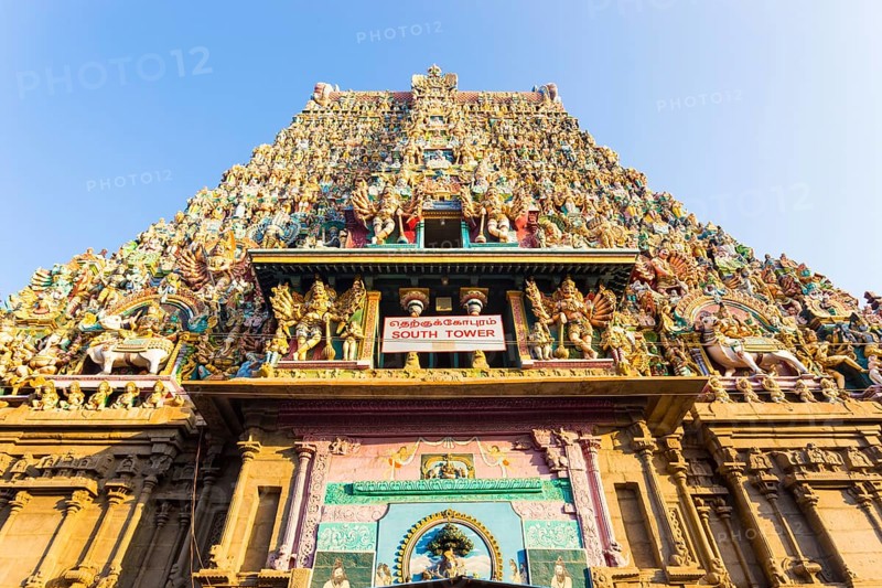 South gateway tower covered in statues of gods at the Meenakshi Amman Temple on a sunny day in south Indian city of Madurai, India, Asia