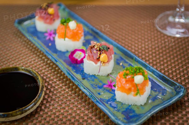 Delicious premium salmon and tuna Oshizushi sushi (Batera sushi) on a decorated handmade porcelain plate