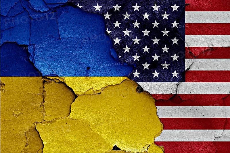 Flags of Ukraine and USA painted on cracked wall
