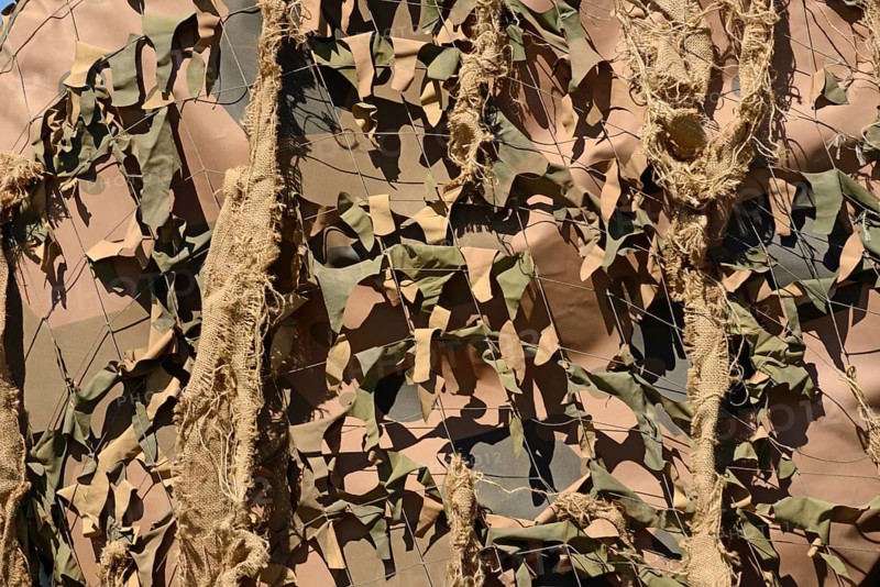 A drab background of army camouflage netting