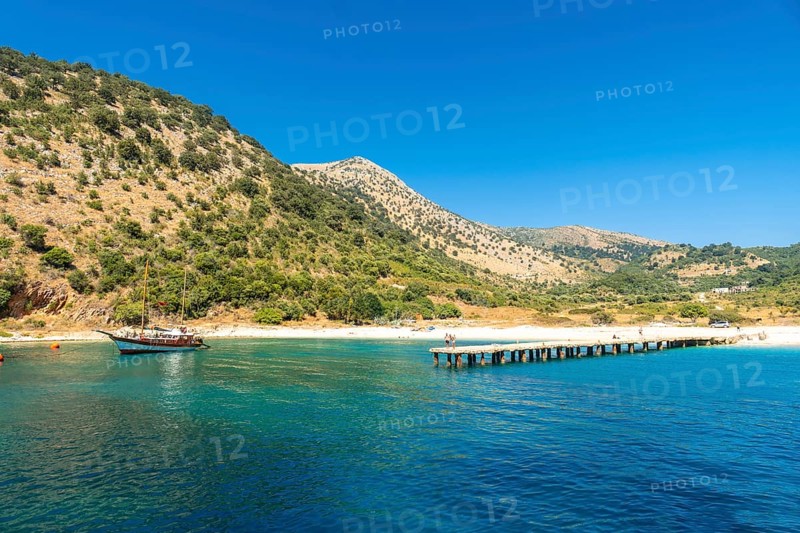 Boat pier at Kakome Beach seen from the boat on the Albanian riviera near Sarande and its turquoise waters, Albania, Europe