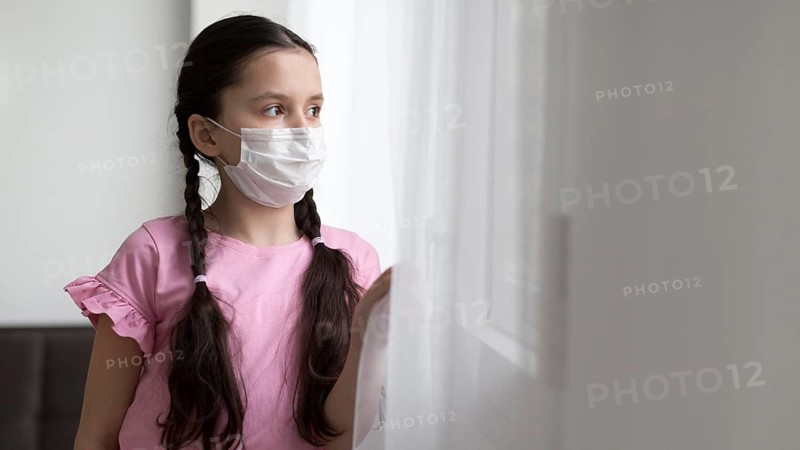 Medium shot girl wearing medical mask