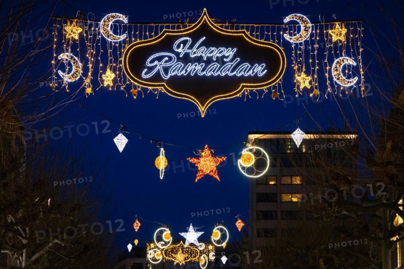 The illuminated lettering Happy Ramadan shines on the evening of 10 March 2024 as part of a light installation stretched across Große Bockenheimer Straße (Fressgass) in Frankfurt am Main. Ramadan is the month of fasting for Muslims and the ninth month of the Islamic lunar calendar. According to Islamic belief, the Koran was revealed during this month. In 2024, Ramadan begins on the evening of 10 March and ends on the evening of 9 April, Große Bockenheimer Straße, Frankfurt am Main, Hesse, Germany, Europe