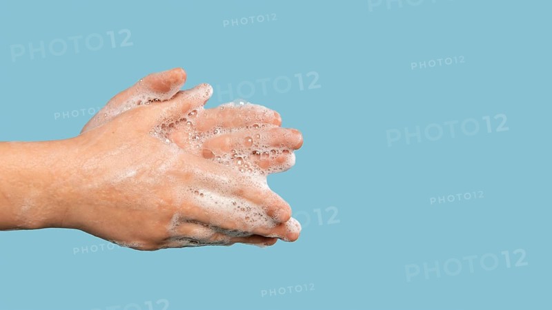 Sideways person washing hands with copy space