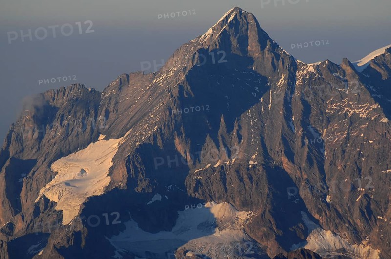 Climate change: Imposing mountain peak with melting glacier in the Bernese Alps | GLobal climate change: Bernese swiss mountain peak with melting glacier