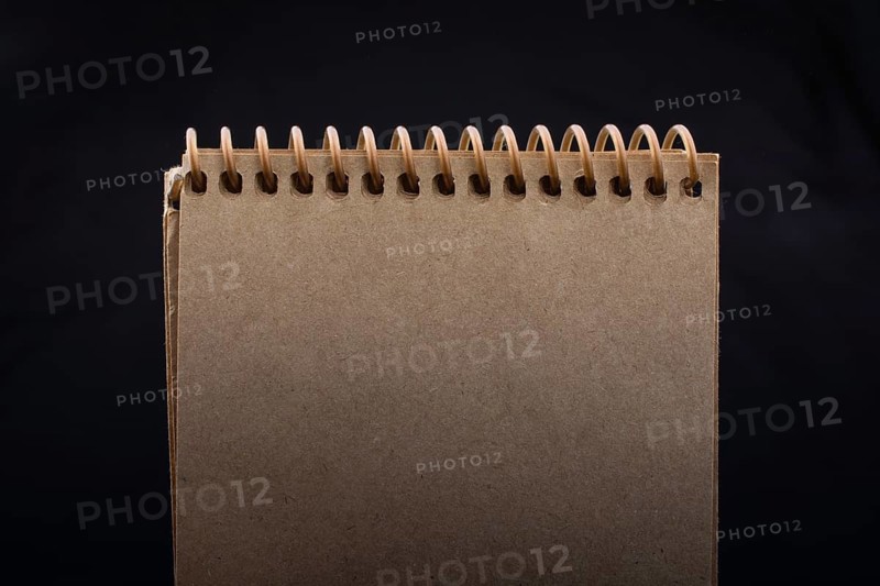 White notebook on a black color background inthe view